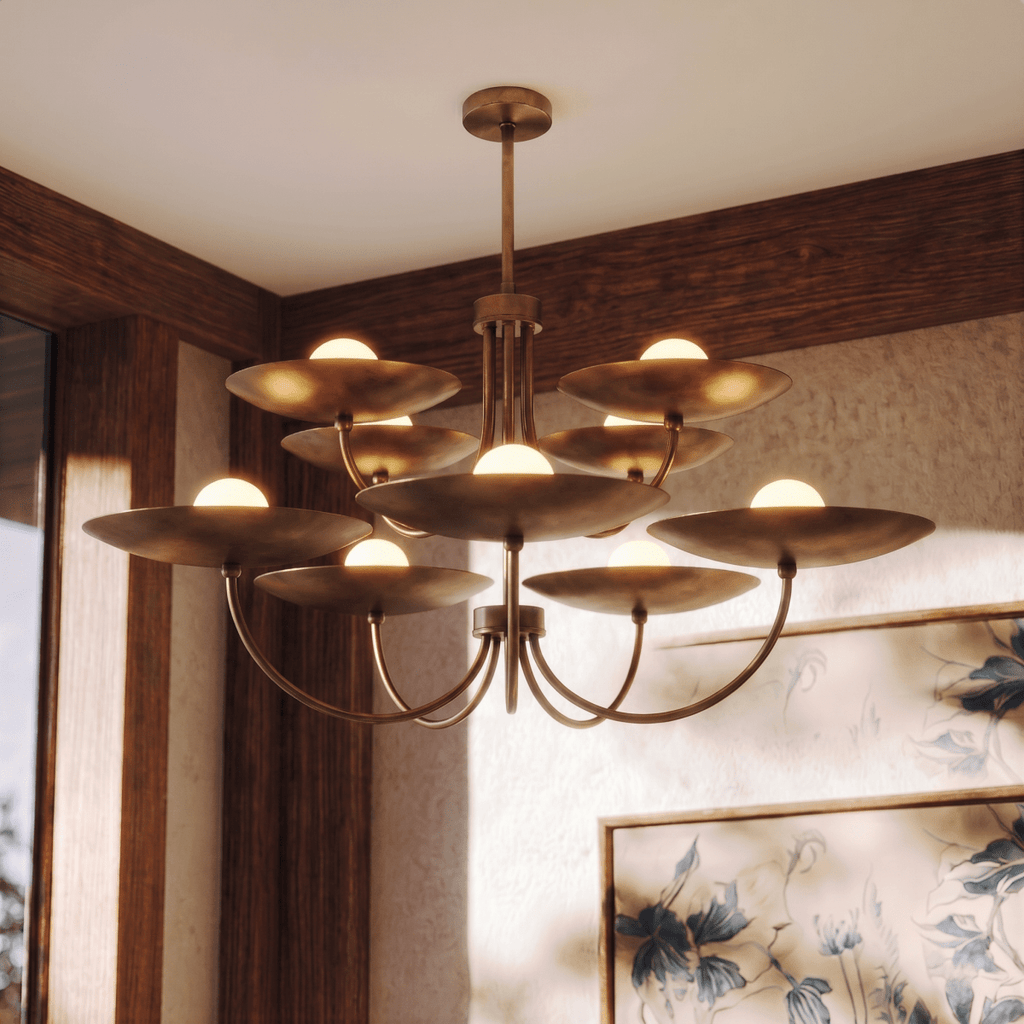 Clérachic vintage brass two-tier disc chandelier lit in a wood-panelled room beside a framed floral print.