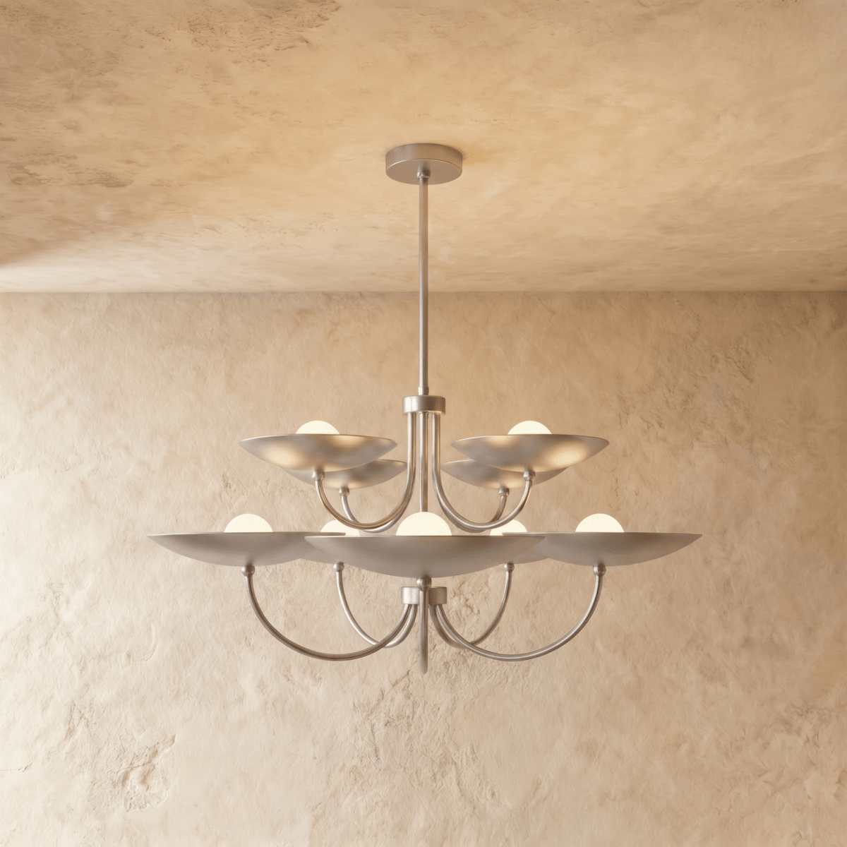Clérachic two-tier disc chandelier in chrome with curved arms, hung from a plaster ceiling in studio light.