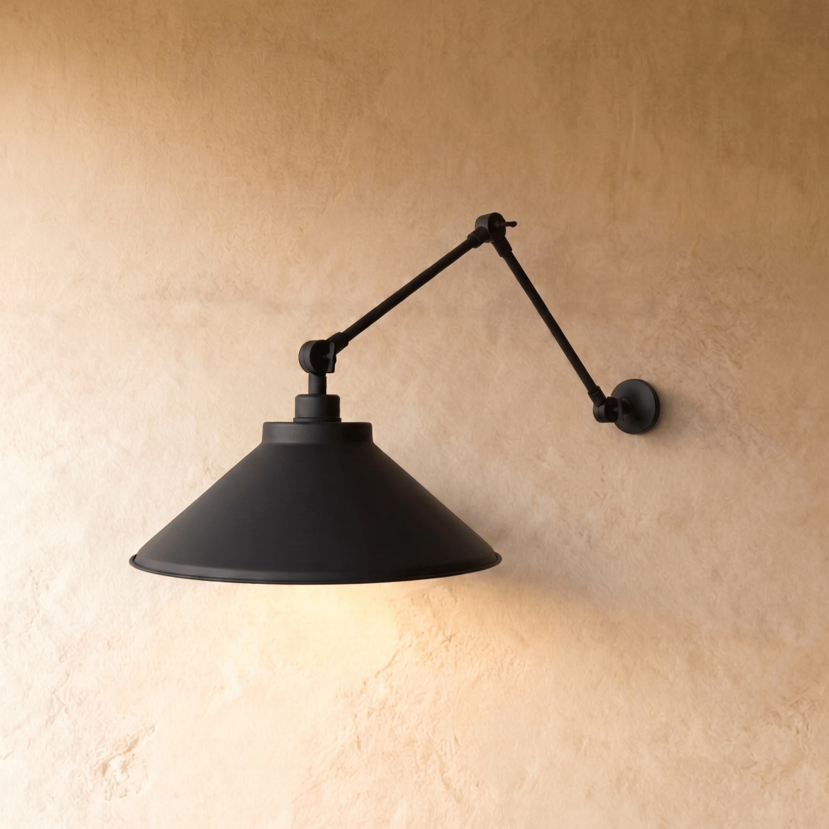 Clérachic wall lamp in matte black, its wide cone shade set on a double-jointed swing arm.