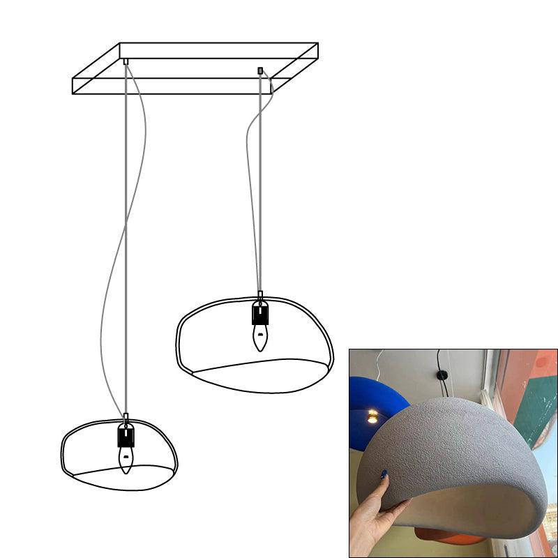 Wabi-sabi organic chandelier glowing over a seating group