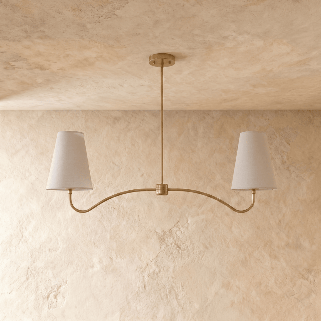 Clérachic double-arm chandelier in polished brass, the curved arms and cone shades viewed from another angle.
