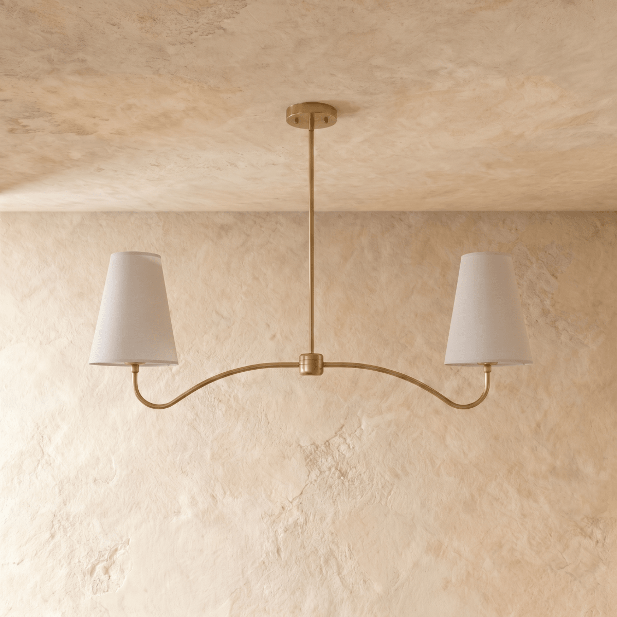 Clérachic double-arm chandelier in polished brass, the curved arms and cone shades viewed from another angle.