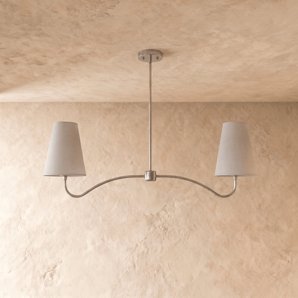 Clérachic double-arm chandelier in chrome, the curved arms and cone shades viewed from another angle.