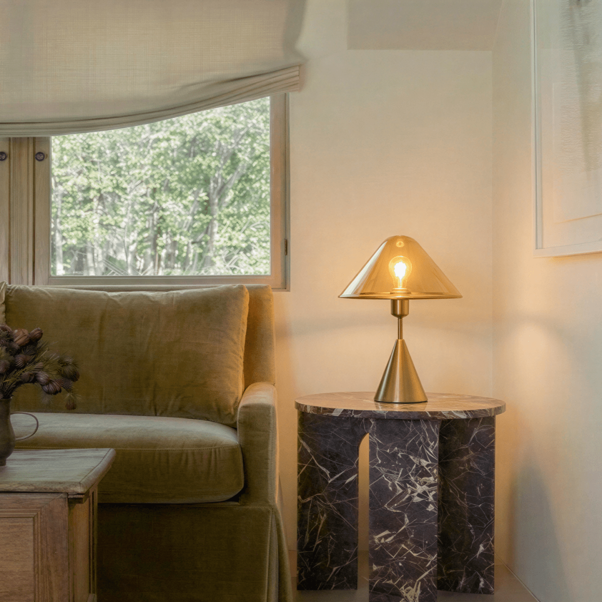 Clérachic cognac dome lamp lit low on a side table at night