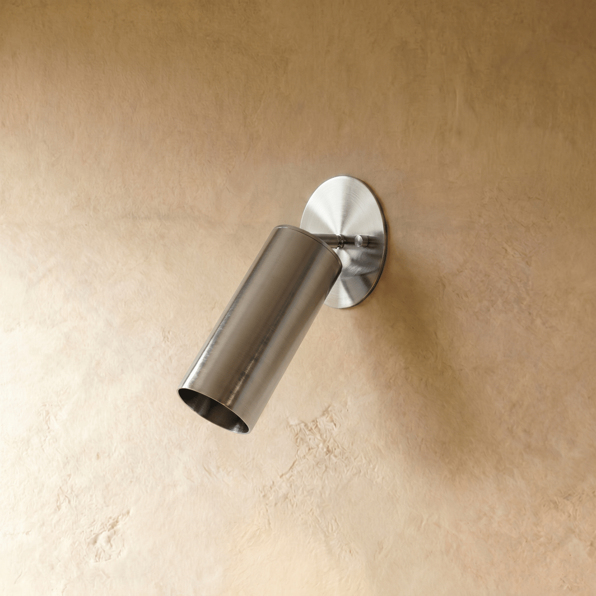 Clérachic wall lamp in chrome, close view of the tilted cylinder shade and slim mounting arm.