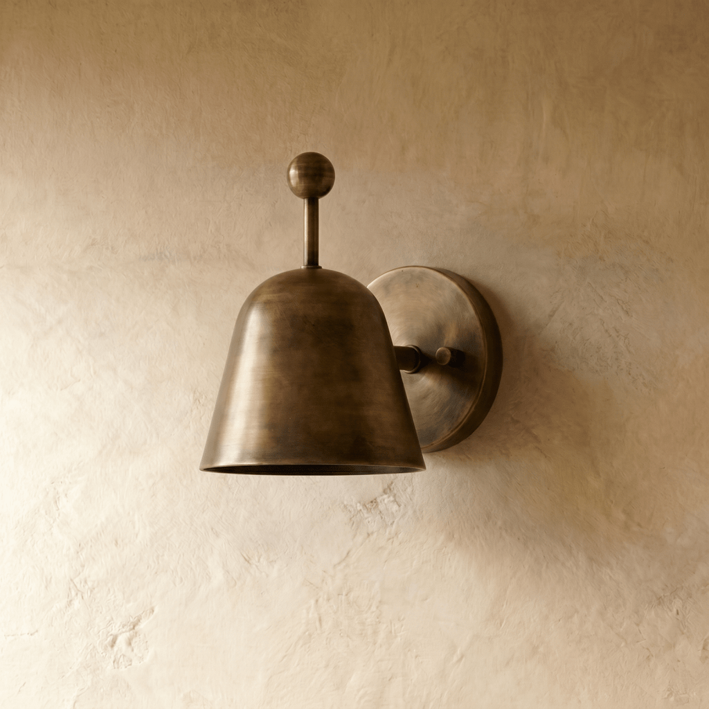 This vintage brass Clérachic wall lamp is shown from another angle, its ball finial catching the light.