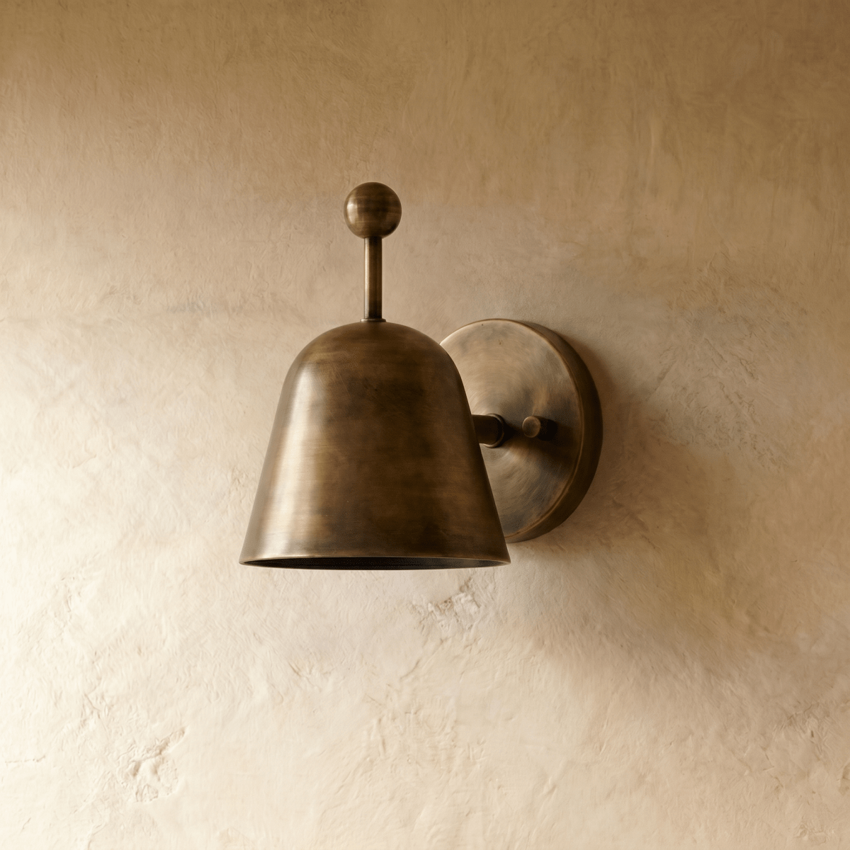 This vintage brass Clérachic wall lamp is shown from another angle, its ball finial catching the light.