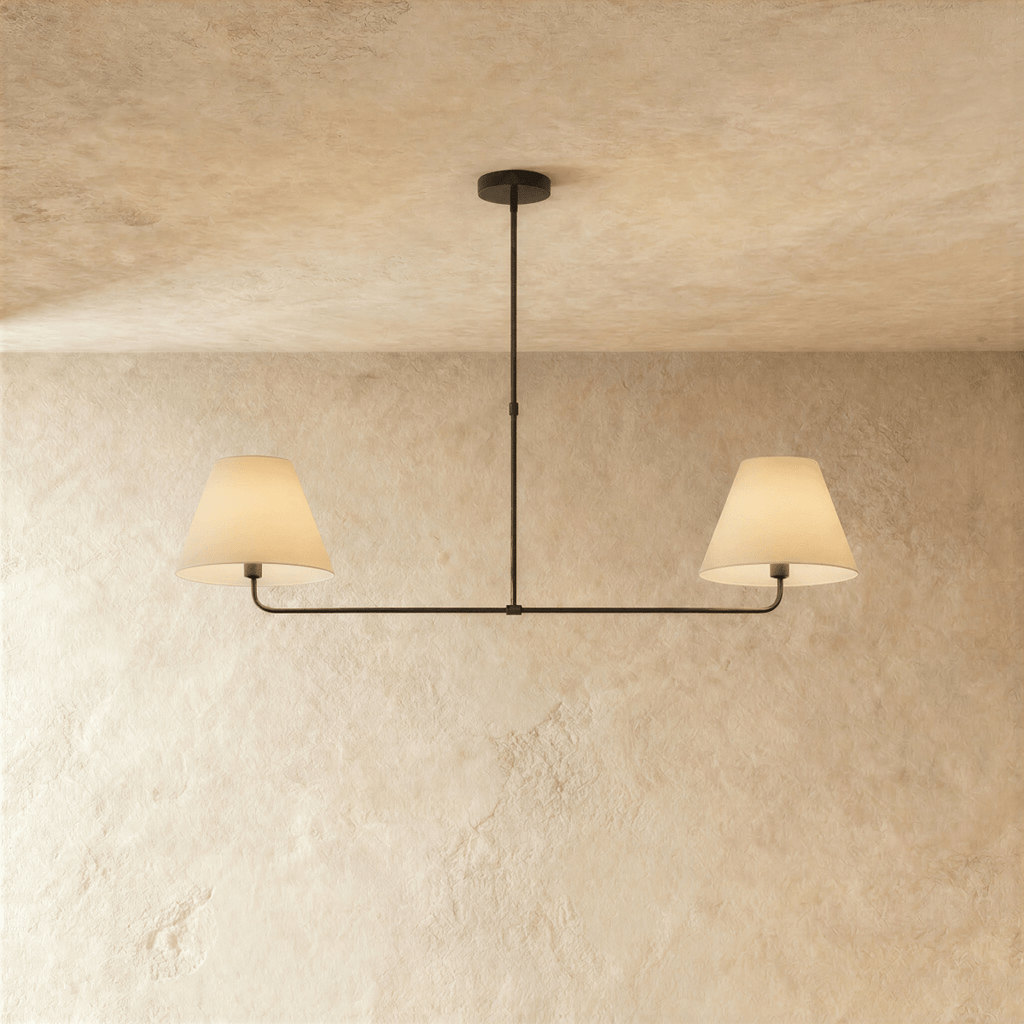 This Clérachic chandelier in matte black, twin linen drum shades on a horizontal bar overhead.