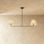 This Clérachic chandelier in matte black, twin linen drum shades on a horizontal bar overhead.