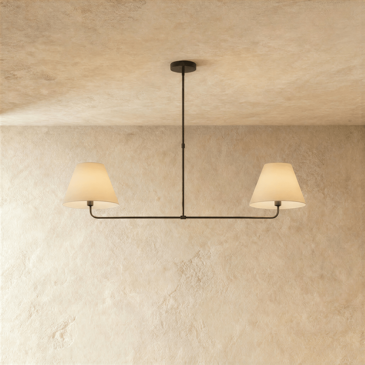 This Clérachic chandelier in matte black, twin linen drum shades on a horizontal bar overhead.