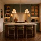 This Clérachic chandelier in brushed brass above a marble kitchen island with green cabinetry.