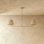 Clérachic chandelier in brushed brass viewed close, the central rod dropping to a paired light bar.