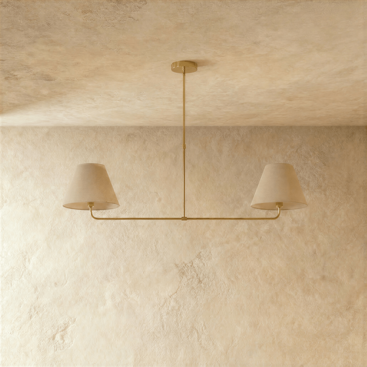 Clérachic chandelier in brushed brass viewed close, the central rod dropping to a paired light bar.