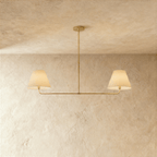 Clérachic chandelier in brushed brass, twin linen drum shades suspended from a horizontal bar.