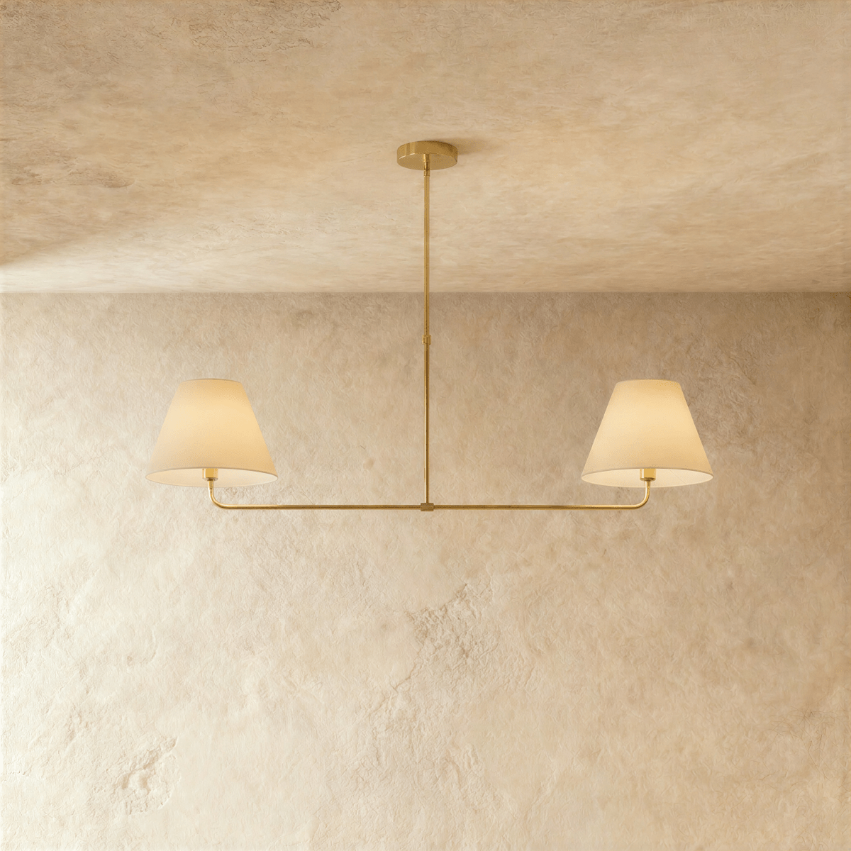 Clérachic chandelier in brushed brass, twin linen drum shades suspended from a horizontal bar.