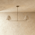 Clérachic chandelier in vintage brass shown from another angle, light glowing beneath both shades.