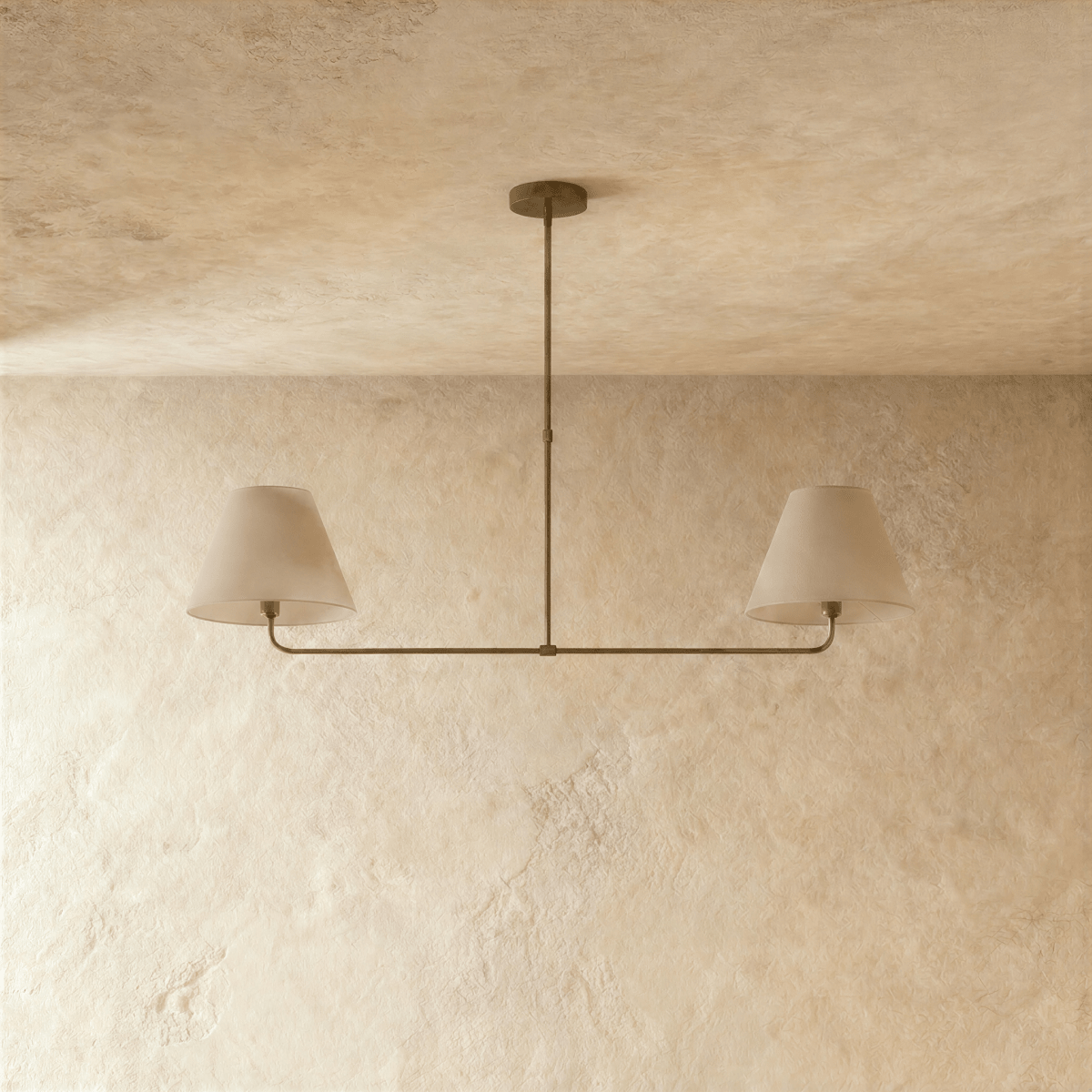 Clérachic chandelier in vintage brass shown from another angle, light glowing beneath both shades.