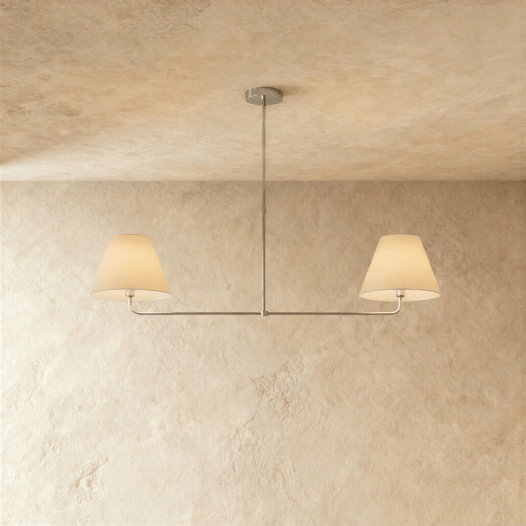 This Clérachic chandelier in chrome, twin linen drum shades suspended from a horizontal bar.