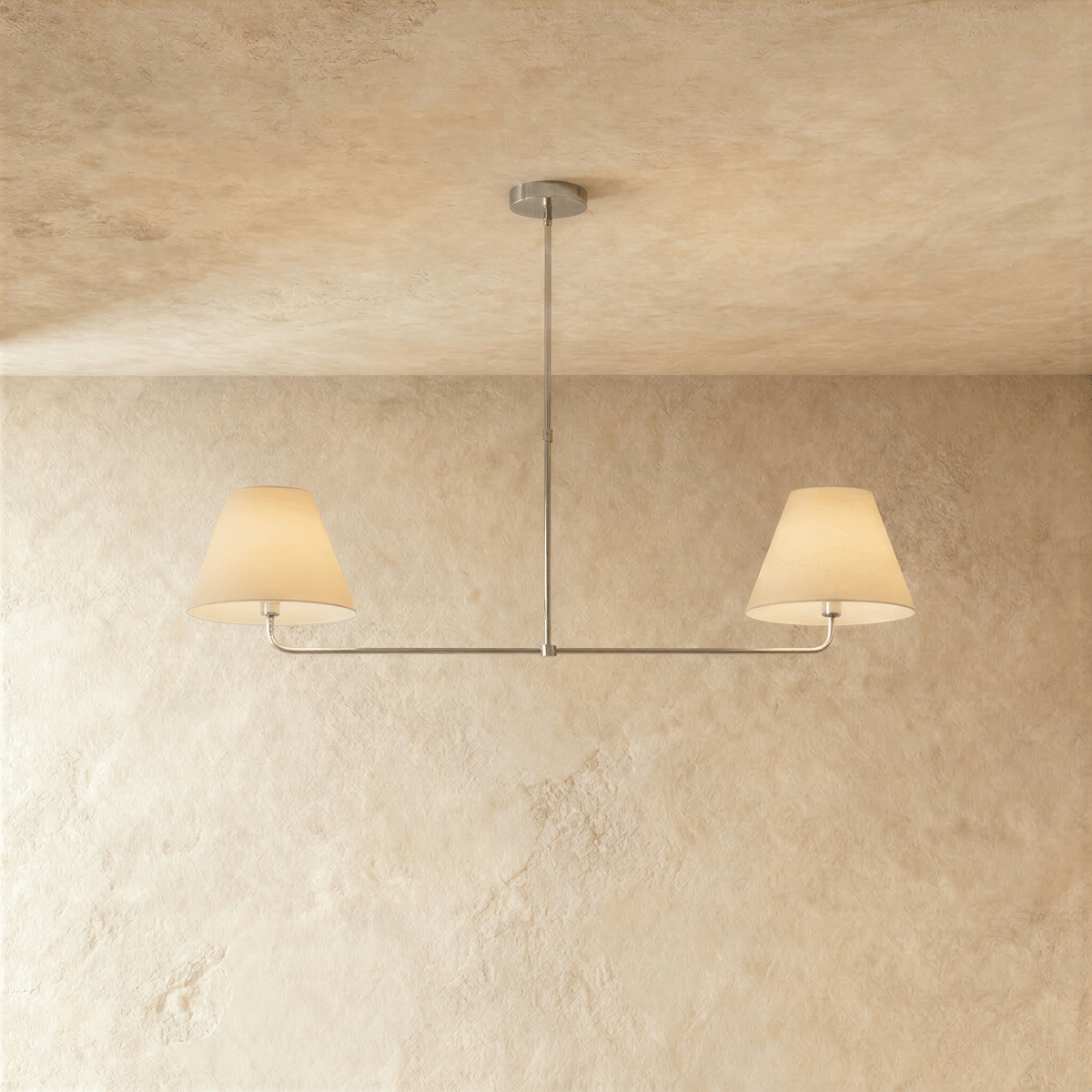 This Clérachic chandelier in chrome, twin linen drum shades suspended from a horizontal bar.