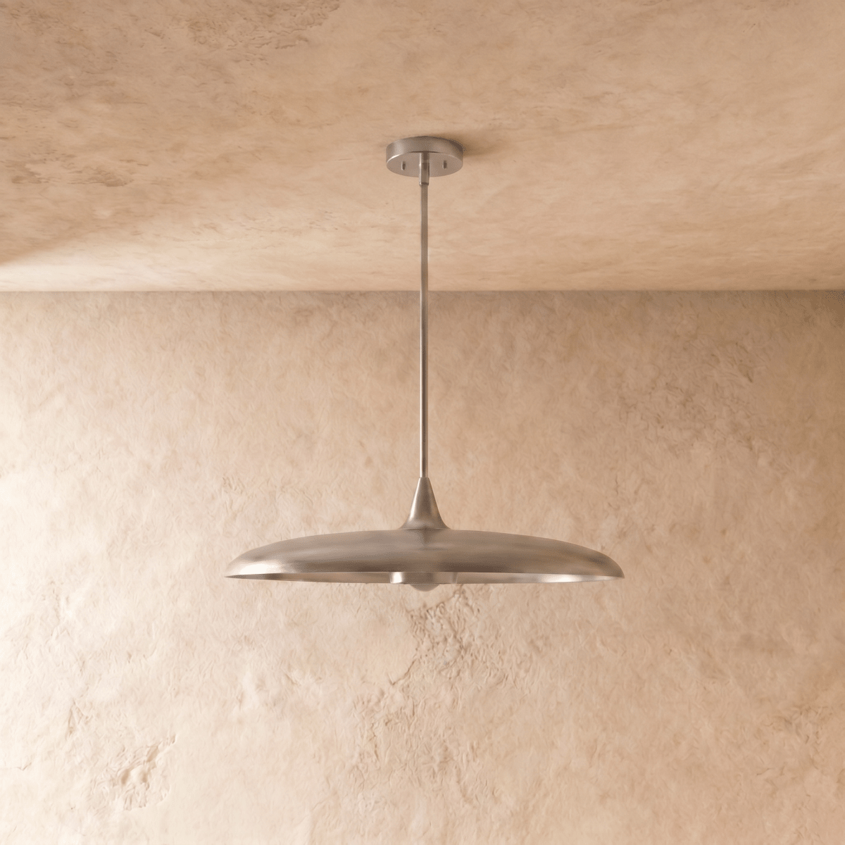 Clérachic pendant light in chrome, the saucer shade and slender rod shown from a slightly different angle.