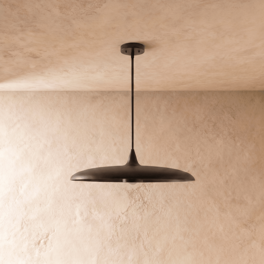 Clérachic pendant light in matte black, the saucer-shaped shade and rod viewed from a slightly different angle.