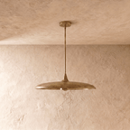 Clérachic pendant light in vintage brass, the saucer-shaped shade and rod viewed from a slightly different angle.