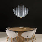 Wirework pendant light casting dramatic shadows on the ceiling