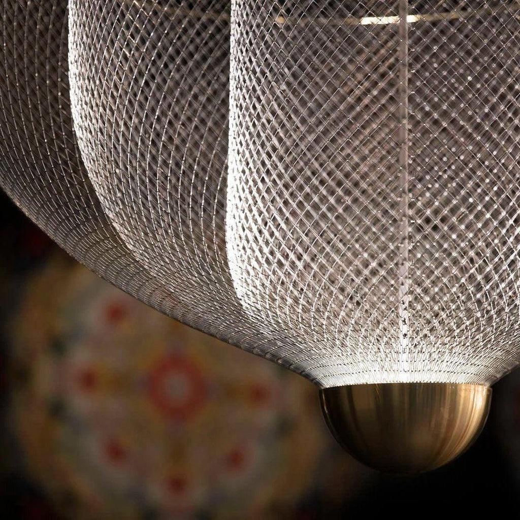 Steel wire pendant light casting layered shadows around it