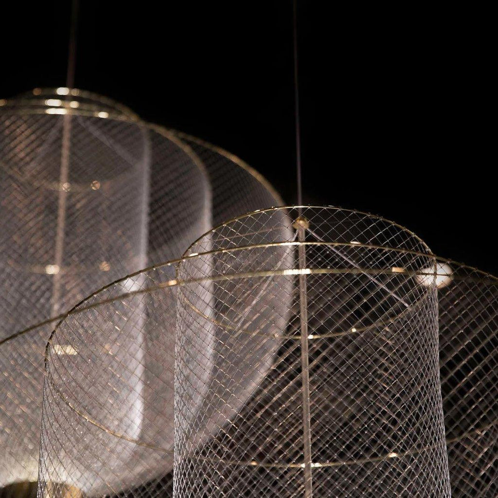 Wirework sphere pendant light glowing in a cozy interior