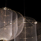 Wirework sphere pendant light glowing in a cozy interior