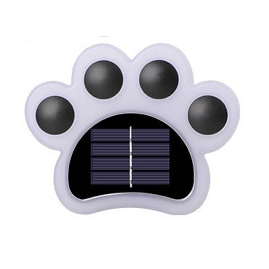 The unlit light on white, its white paw body holding four black toe lenses around a solar panel.