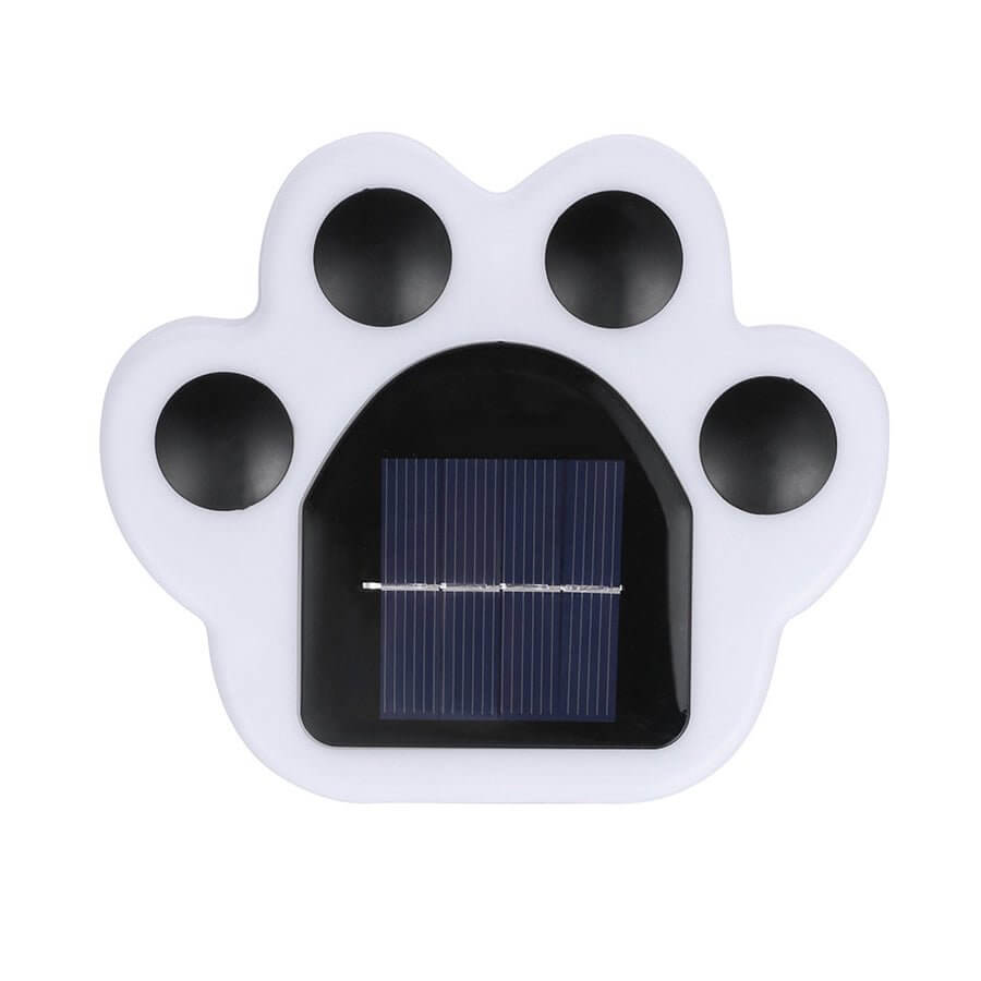 Straight-on view of the unlit paw light, showing the arched solar panel set into the white housing.