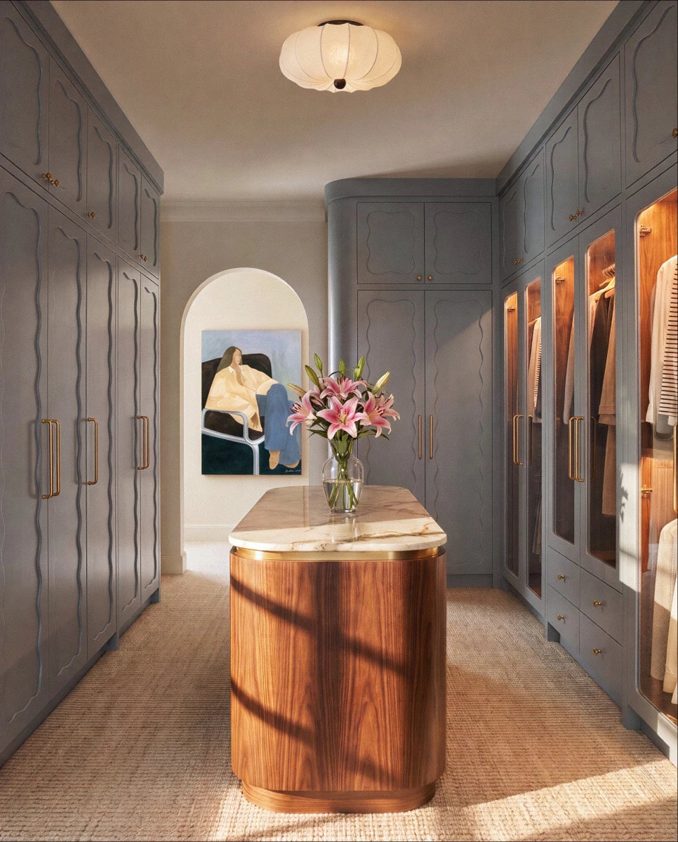 Clérachic ceiling light glowing above a walk-in closet with a marble-topped island and grey cabinetry.