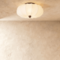 Clérachic ceiling light with a scalloped fabric drum shade and a dark wood finial, mounted flush overhead.