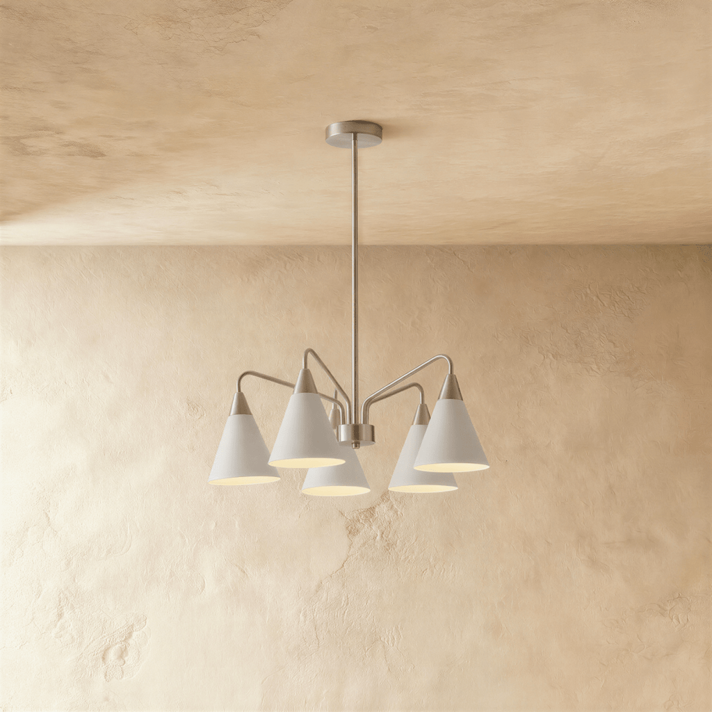 This Clérachic chandelier hangs from a plaster ceiling with five cone shades fanned out in soft white metal.