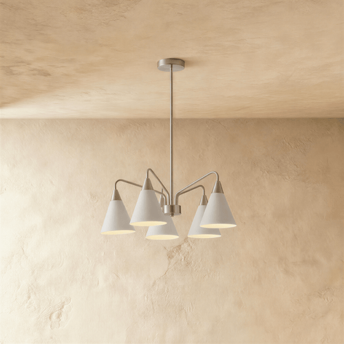 This Clérachic chandelier hangs from a plaster ceiling with five cone shades fanned out in soft white metal.