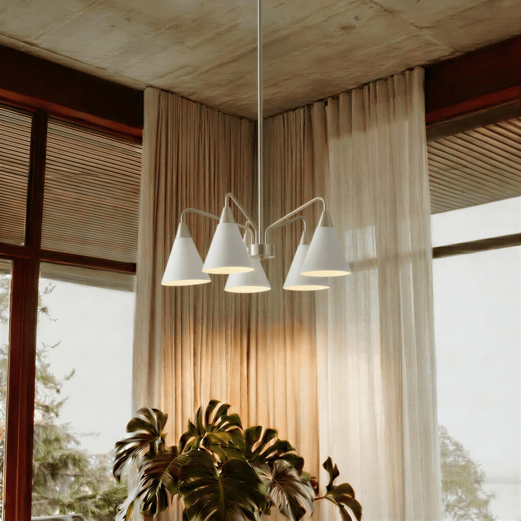 This Clérachic five-arm chandelier glows warmly in a curtained corner beside a large potted monstera.