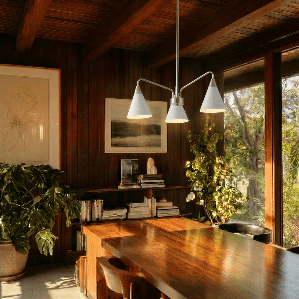 A Clérachic three-arm chandelier lights a wood-beamed dining table in a home overlooking the water.