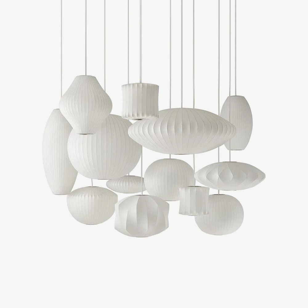 White saucer bubble pendant light shown lit against a backdrop