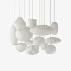 White saucer bubble pendant light shown lit against a backdrop