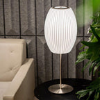 Chrome-stemmed faux silk bubble table lamp glowing in a cosy living room