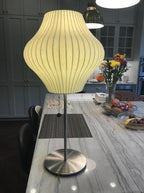 Faux silk bubble table lamp on a bedside table casting a soft diffused glow