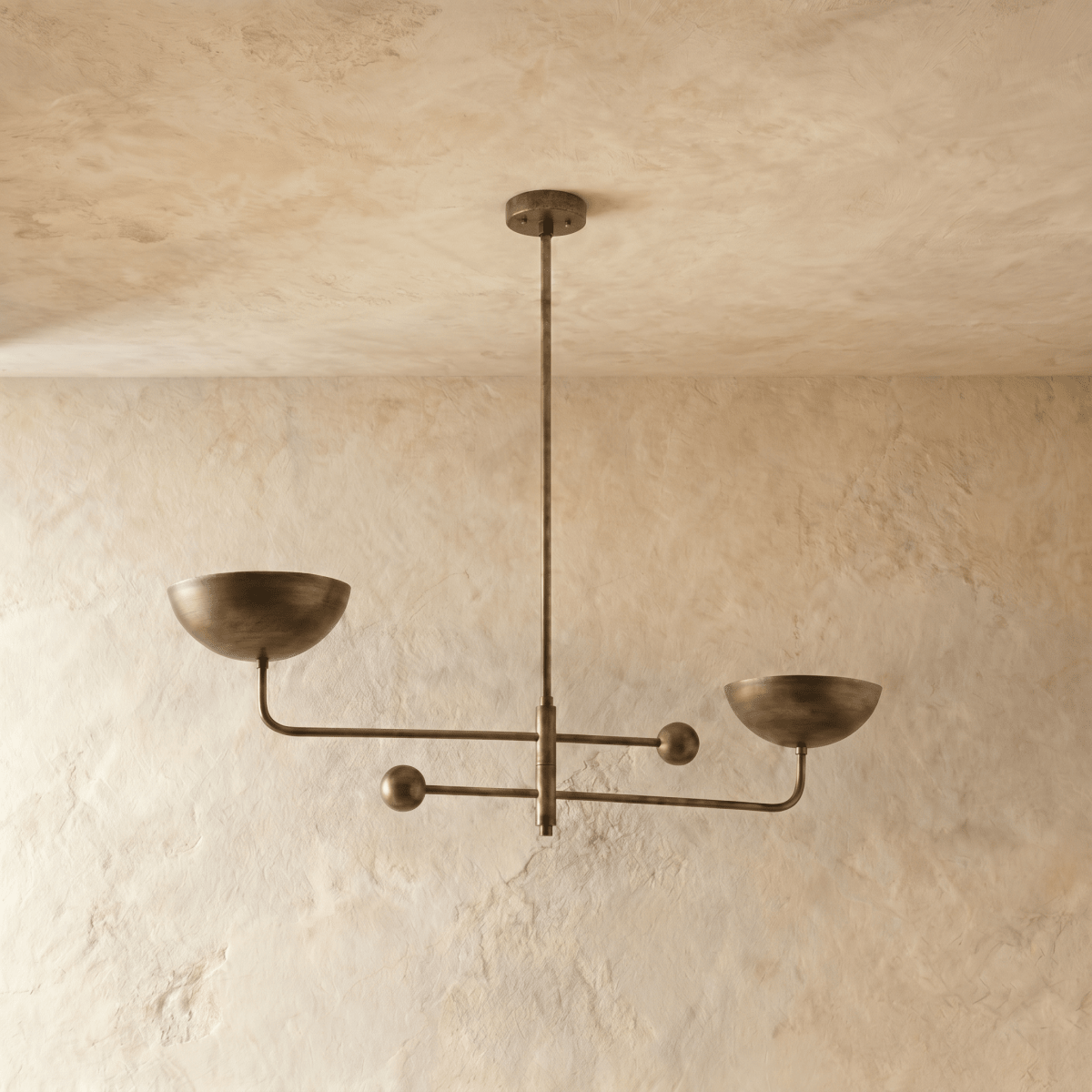 Clérachic chandelier in vintage brass, the crossed brass arms and bowl shades viewed from another angle.