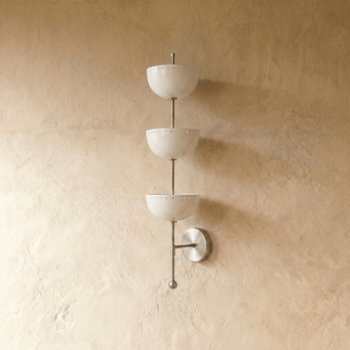 Clérachic three-tier bowl sconce in chrome, shown from a slightly closer studio angle on a plaster wall.