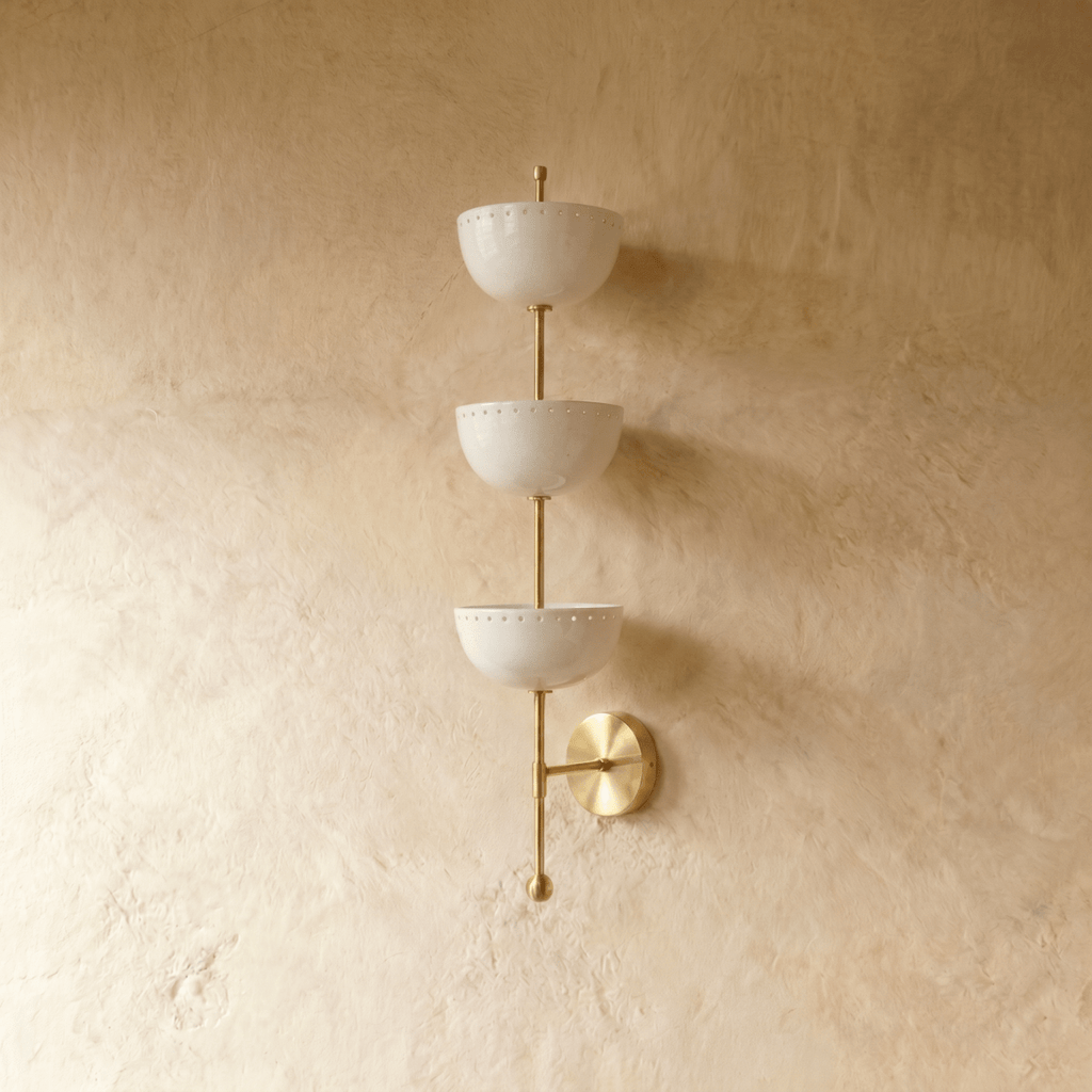 Clérachic three-tier bowl sconce in polished brass, shown from a slightly closer studio angle on a plaster wall.
