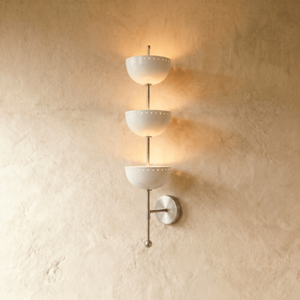 Clérachic three-tier bowl sconce in chrome with white glass shades, mounted on a plaster wall in studio light.
