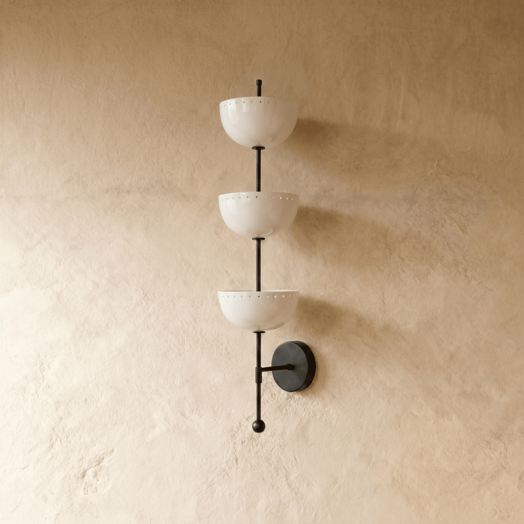 Clérachic three-tier bowl sconce in matte black, shown from a slightly closer studio angle on a plaster wall.
