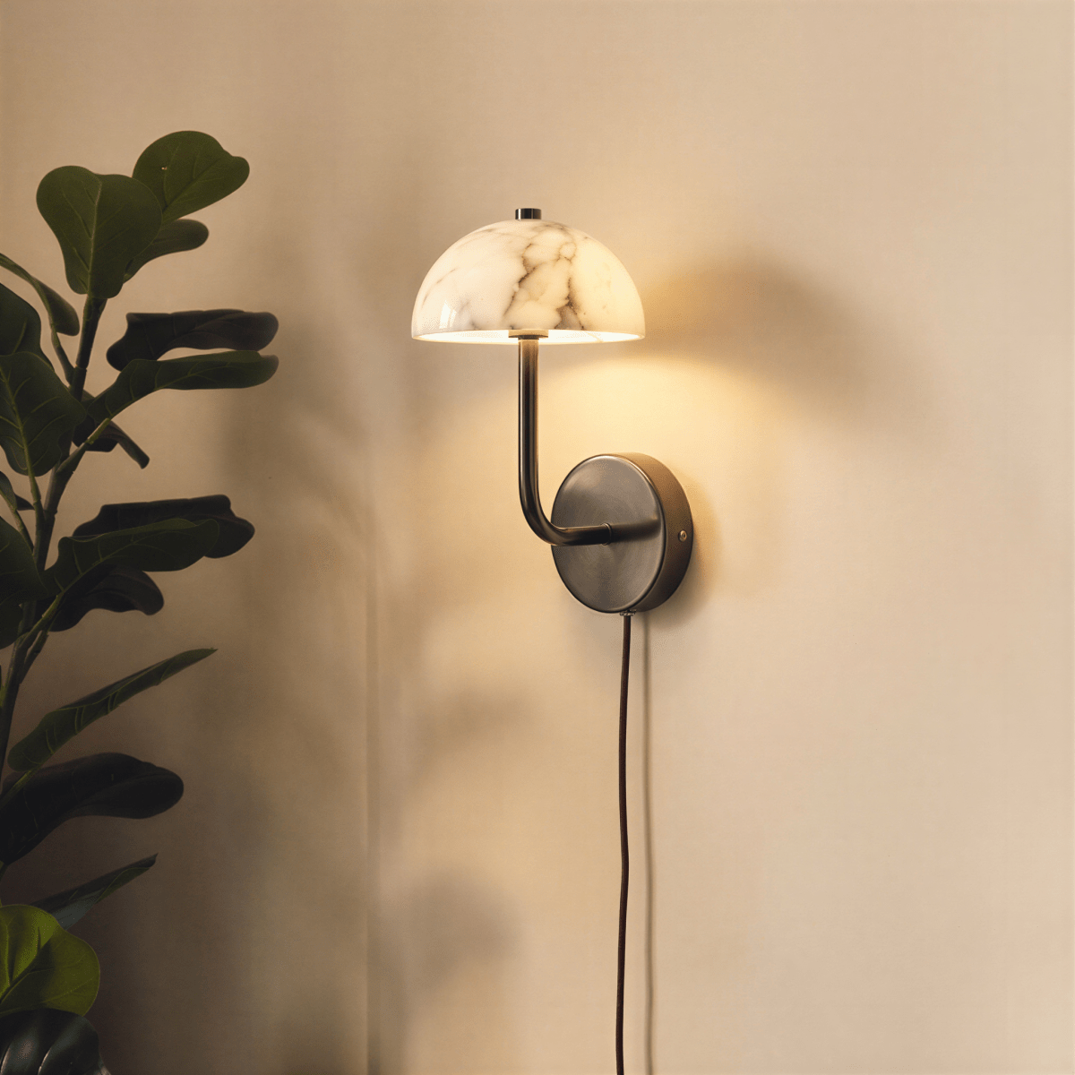 Clérachic marble dome wall light lit warm above a nightstand