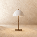 Clérachic table lamp in vintage brass with a glossy white dome shade on a slender stem and round base.