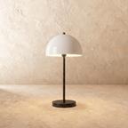 Clérachic table lamp in matte black, its glossy white dome shade rising from a slender black stem.
